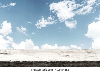 Empty wooden deck table over sky background for product montage