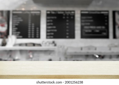 Empty Wooden Desk With Blurry Background Of Cafe And Coffeeshop.