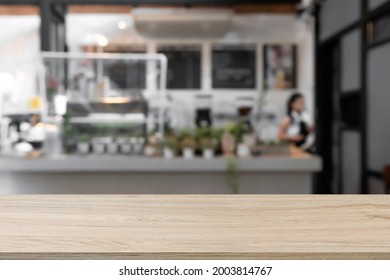 Empty Wooden Desk With Blurry Background Of Cafe And Coffeeshop.