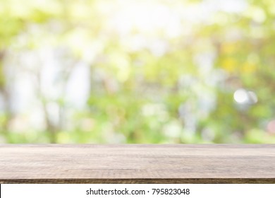 Empty Wooden Desk Of Free Space And Spring Time With Blurred Background Of Home Garden For A Catering Or Food Background,Template Mock Up For Display Montages Of Product.
