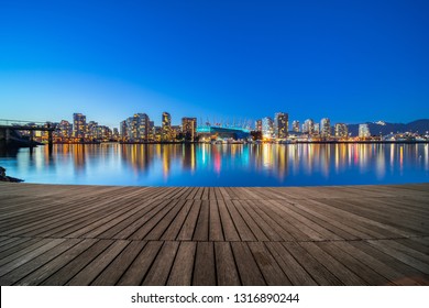 empty wooden dock with skyline background at night, vancouver, canada. - Powered by Shutterstock