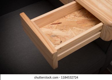 An empty wooden drawer isolated on black background