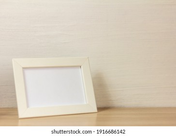 An Empty Wooden Photo Frame On A Table Or Shelf With A Copy Of The Space.