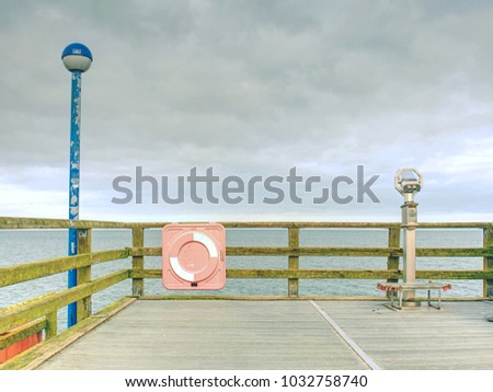 Similar – wooden platform with blue posts with ropes and orange lifebuoys on the background of the sea and sky with clouds Egypt Dahab South Sinai