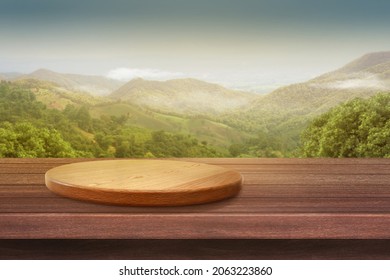 Empty wooden plate on the table with Mountain soft blurry background, of free space for your copy and branding. Use as products display montage. Vintage style concept. - Shutterstock ID 2063223860