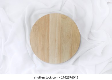 Empty  Wooden Plate On White Silk Background. Eco Friendly Minimalist Table Setting. Mock Up Restaurant Menu Flat Lay. Top View.