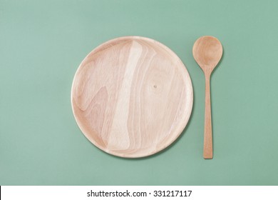 Empty Wooden Plate And Spoon With Pastel Background