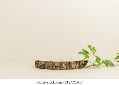 Empty wooden podium with green ivy leaves, display for eco-friendly, organic product presentation, neutral beige background