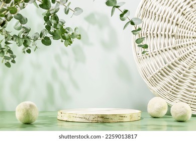 Empty wooden podium with laundry balls on blue background with eucalyptus leaves. Natural display for presentation. Eco friendly showcase for new home cleaning or laundry products and promotion sale - Shutterstock ID 2259013817