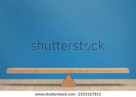 Empty wooden scales on a blue background. The concept of equilibrium and balance. High quality photo with copy space.