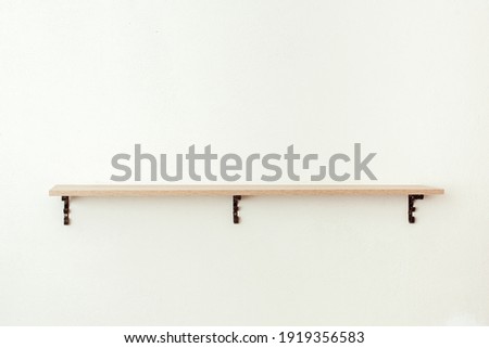 Empty wooden shelf on white cement wall background, product display montage