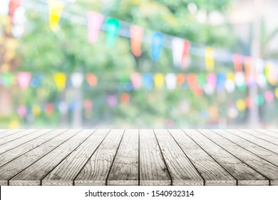 Empty Wooden Table With Birhday Party In Garden Background Blurred.