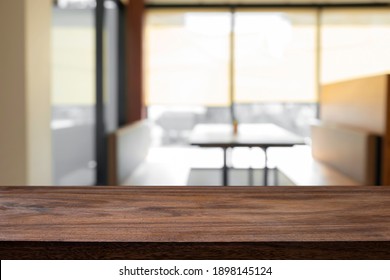 Empty Wooden Table With Blur Background Of Office And Meeting Room.