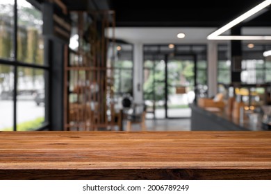 Empty Wooden Table With Blurred Background Of Coffee And Bakery Shop.