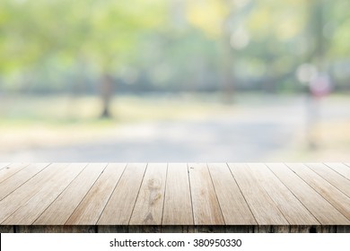 Empty Wooden Table With Blurred City Park On Background