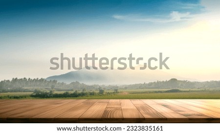 Empty wooden table with blurred mountain view background. Free space can be used for montage or product display design and advertising
