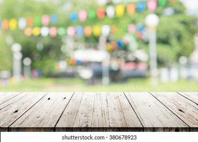 Empty Wooden Table With Blurred Party On Background,  Fun / Spring Concept