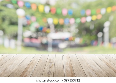 Empty wooden table with blurred party on background,  fun / spring concept