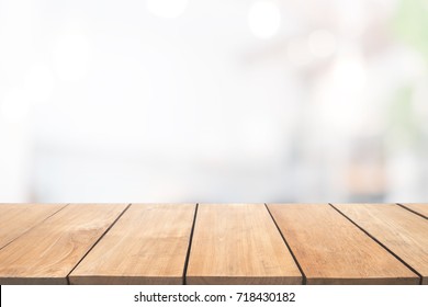 Empty wooden table and blurred people in cafe background, product display.Ready for product montage - Shutterstock ID 718430182