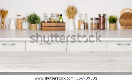 Empty wooden table with bokeh image of kitchen bench interior