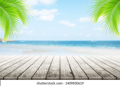 
Empty Wooden Table Or Dock Floor And Palm Leaves With Blurred Background, Beach And Beautiful Sea In Daytime.