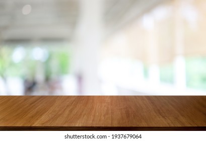 Empty wooden table in front of abstract blurred background of coffee shop . wood table in front can be used for display or montage your products.Mock up for display of product - Shutterstock ID 1937679064
