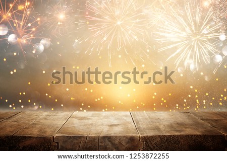 Empty wooden table in front of fireworks background. Product display montage