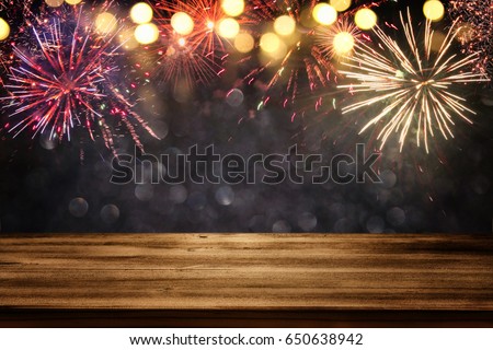 Empty wooden table in front of fireworks background. Product display montage