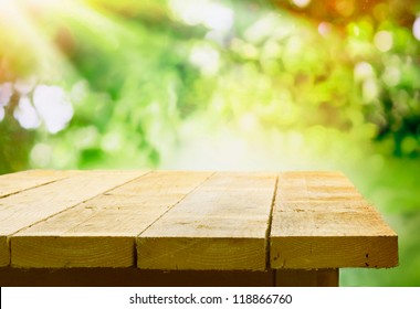 Empty Wooden Table With Garden Bokeh For A Catering Or Food Background With A Country Outdoor Theme