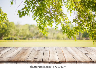 Empty wooden table with garden bokeh for a catering or food background with a country outdoor theme,Template mock up for display of product - Shutterstock ID 579104974