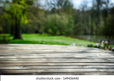 Empty Wooden Table In Green Spring Garden