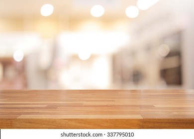 Empty wooden table and interior background, product display,blurred store with bokeh - Shutterstock ID 337795010