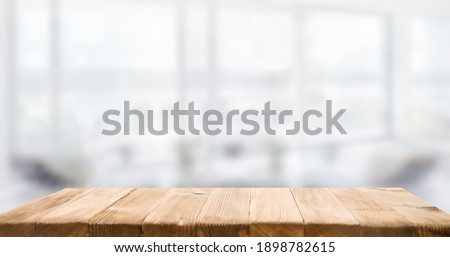 empty wooden table on background of abstract blur white interior, montage, product display, inside and window.
