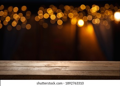 Empty Wooden Table On Blurred Light Gold Bokeh Of Cafe Restaurant On Dark Background, Place For Your Products On The Table