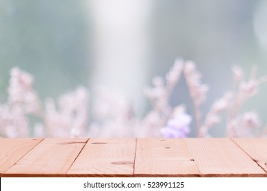 Empty Wooden Table On Defocuced Winter Window With Winter Flower Background .