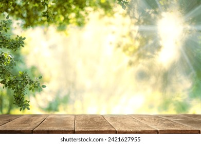 Empty wooden table on nature outdoor for free space for product. Spring beautiful background - Powered by Shutterstock