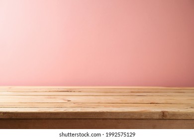 Empty Wooden Table Over Pink Wall Background. Interior Mock Up For Design And Product Display.