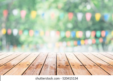 Empty Wooden Table With Party In Garden Background Blurred.