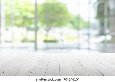 Empty wooden table with party in garden background blurred. - Shutterstock ID 704246104
