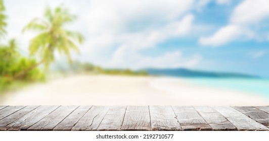 Empty wooden table or pier with sunny beach and sea on background. With copy space for your product