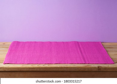 Empty Wooden Table With Pink Mat Over Purple Background. Kitchen Or Restaurant Counter Mockup For Design