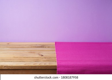 Empty Wooden Table With Pink Mat Over Purple Background. Kitchen Or Restaurant Counter Mockup For Design