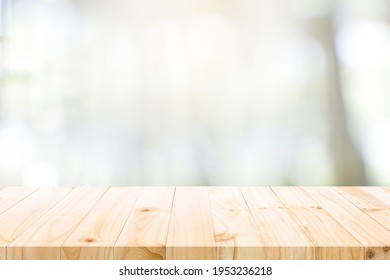 Empty wooden table for present product on coffee shop or soft drink bar blur background with bokeh image. - Shutterstock ID 1953236218