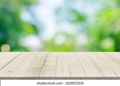 Empty wooden table for product placement or montage with focus to table top in the foreground, with white background. Wooden board empty table perspective.
