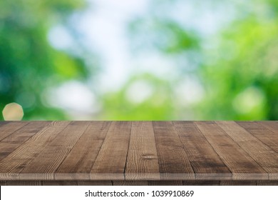 Empty wooden table for product placement or montage with focus to table top in the foreground, with white background. Wooden board empty table perspective.