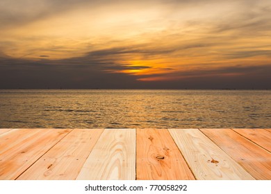 empty wooden table and the sky and sea view in sunset time