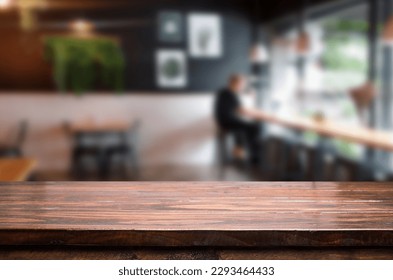 empty wooden table with smoke float up on dark background - Dark wood texture background surface with old natural pattern - wood table on blur of cafe, coffee shop, bar, background - can used for disp