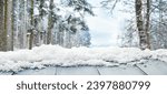 Empty wooden table in snowy forest on winter day