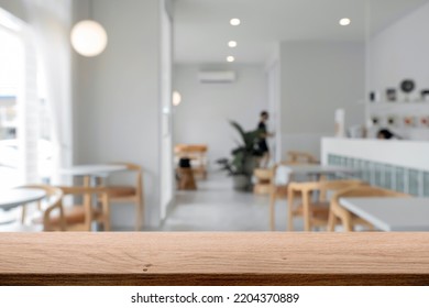 Empty wooden table space platform and blurred cafe or restaurant background for product display montage. - Powered by Shutterstock