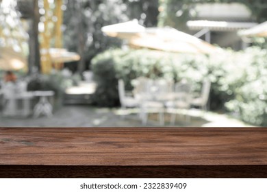Empty wooden table space platform and blurred cafe or restaurant background for product display montage.